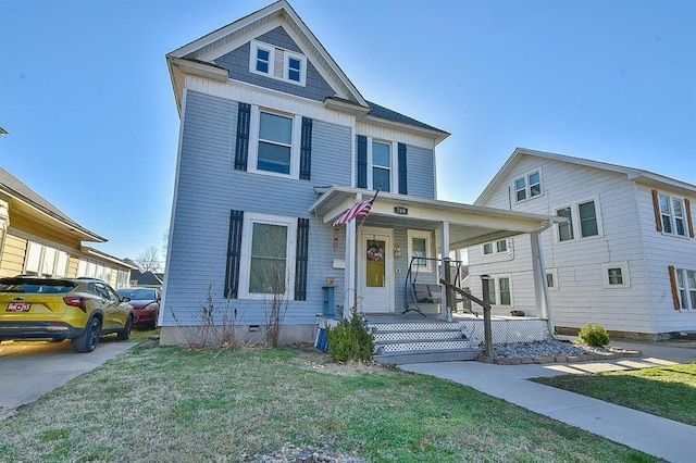 view of front facade featuring crawl space, covered porch, and a front lawn