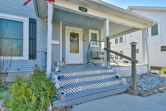 entrance to property featuring a porch