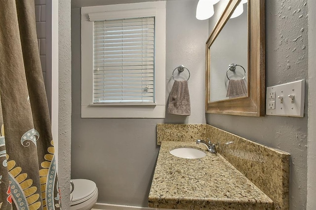 bathroom featuring toilet and vanity