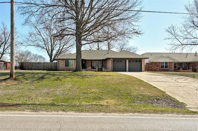 single story home featuring a front yard, fence, driveway, an attached garage, and brick siding