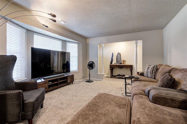 living room featuring visible vents, a textured ceiling, and carpet flooring