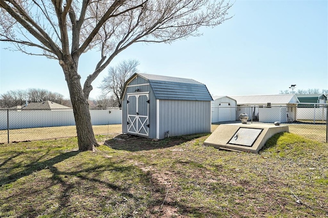 exterior space with a fenced backyard, a storage unit, and a yard