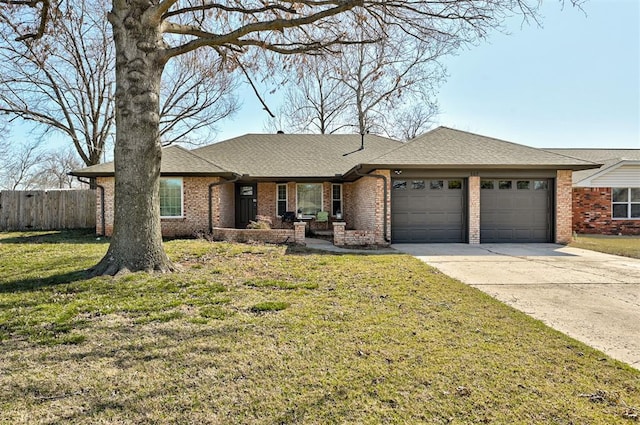 ranch-style home with a front yard, fence, a garage, and driveway