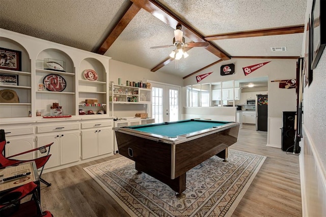 rec room featuring light wood finished floors, visible vents, lofted ceiling with beams, french doors, and a textured ceiling