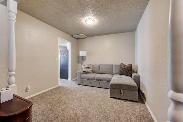 living area with baseboards, a textured ceiling, carpet flooring, and a textured wall