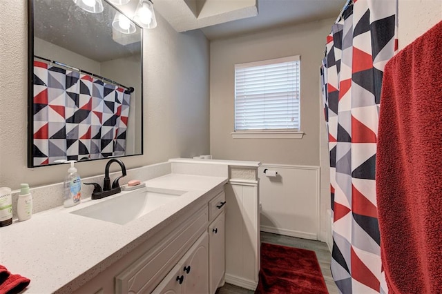 full bath with vanity and a shower with shower curtain