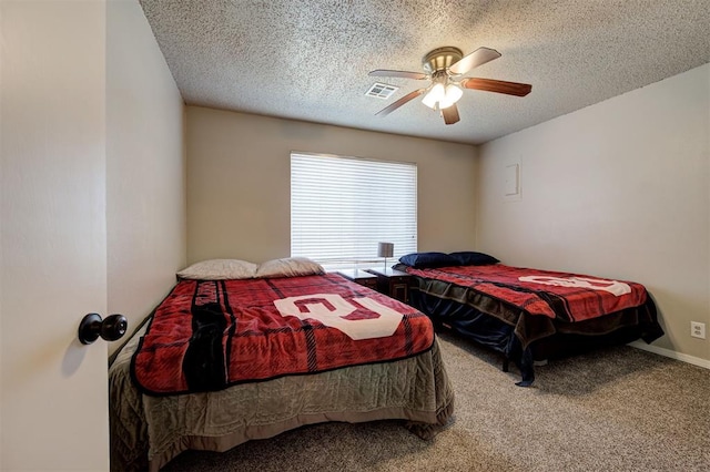 carpeted bedroom with visible vents, baseboards, a textured ceiling, and ceiling fan