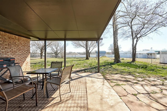 view of patio with outdoor dining space and fence