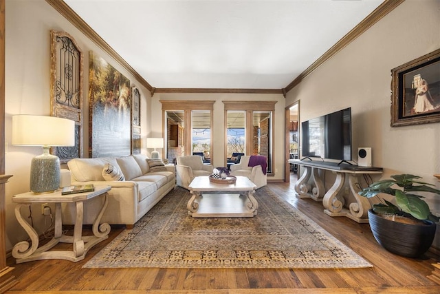 living area featuring wood finished floors and crown molding