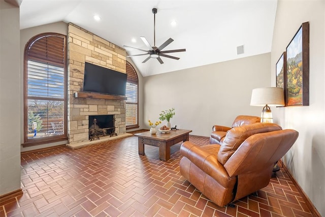 living room featuring visible vents, a stone fireplace, baseboards, a healthy amount of sunlight, and ceiling fan