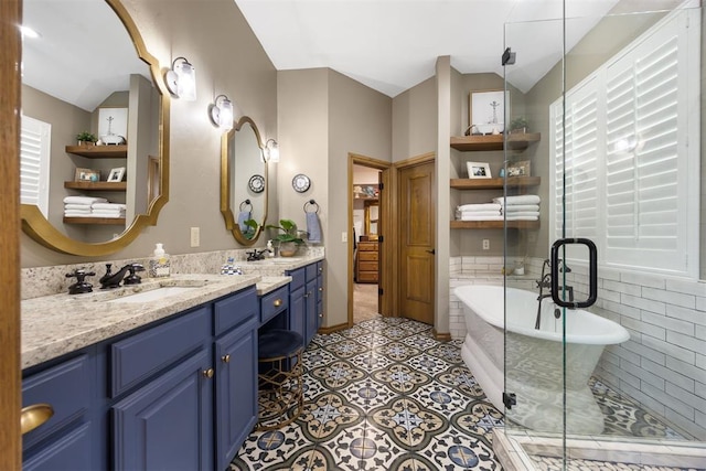 bathroom with a stall shower, a sink, tile patterned flooring, double vanity, and a soaking tub