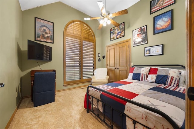 bedroom featuring baseboards, lofted ceiling, carpet, and a ceiling fan