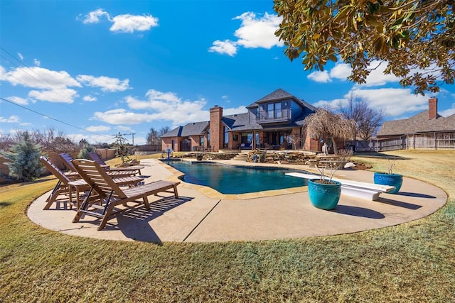 view of swimming pool with a yard, a patio, a fenced in pool, and fence