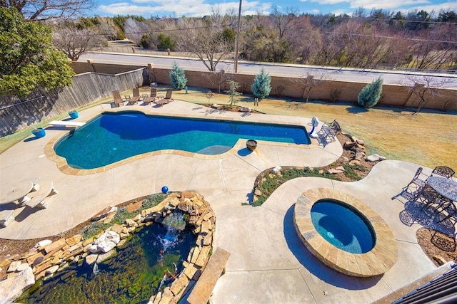 view of swimming pool with a patio, a fenced backyard, a diving board, a fenced in pool, and an in ground hot tub