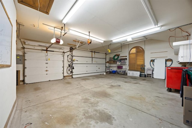 garage with electric panel and a garage door opener