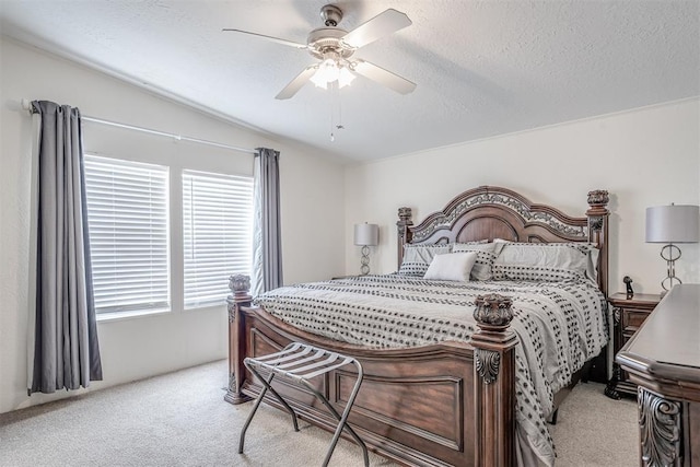 bedroom with light carpet, a textured ceiling, ceiling fan, and vaulted ceiling