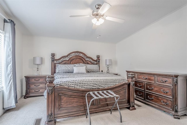 bedroom with light carpet, visible vents, and ceiling fan