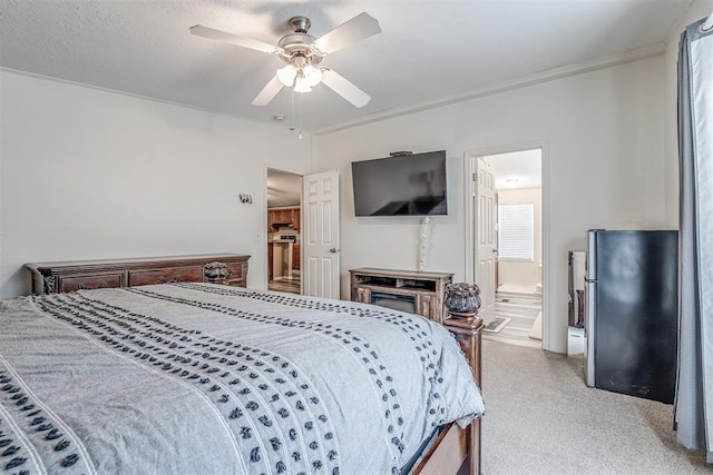 bedroom with ensuite bath, crown molding, and a ceiling fan