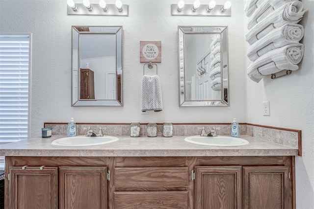 full bathroom featuring a sink and double vanity