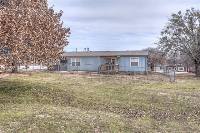 back of house featuring a yard, central AC, and fence