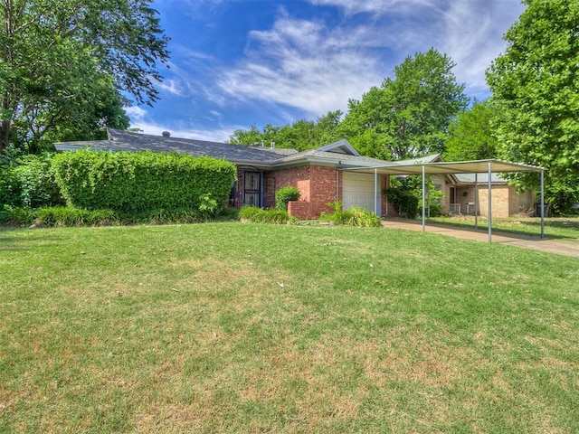 view of front of house with a front lawn, a carport, concrete driveway, an attached garage, and brick siding