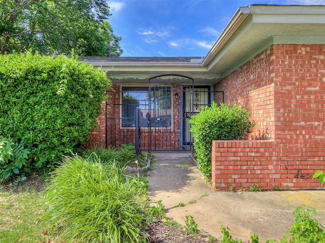 entrance to property featuring brick siding