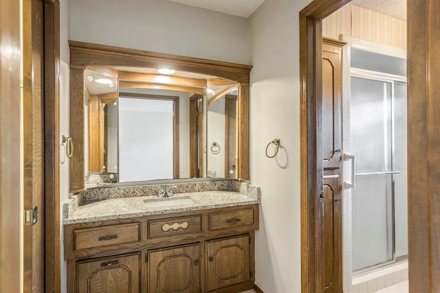 bathroom with vanity and a stall shower