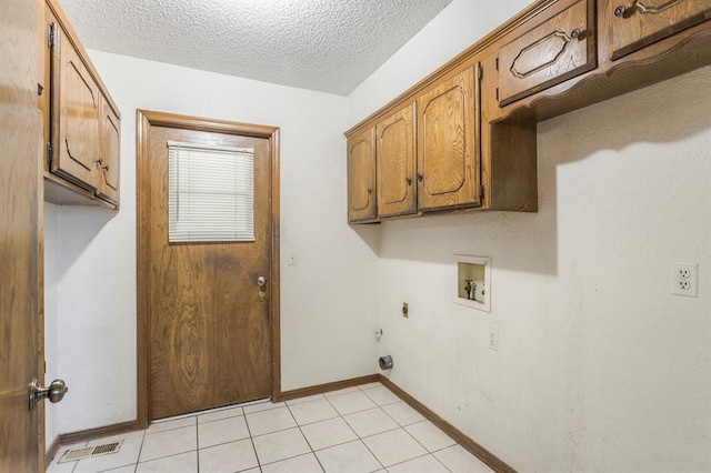 washroom featuring baseboards, washer hookup, cabinet space, electric dryer hookup, and a textured ceiling