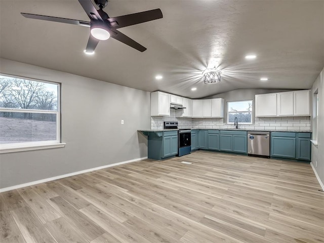 kitchen featuring lofted ceiling, decorative backsplash, stainless steel dishwasher, electric range, and a sink