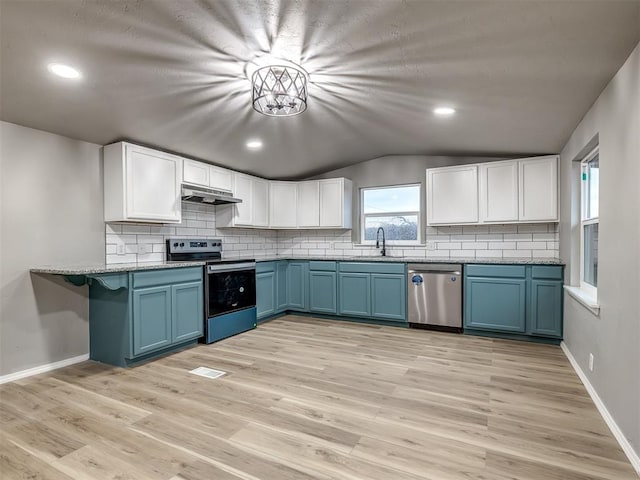 kitchen with a sink, stainless steel appliances, under cabinet range hood, white cabinetry, and blue cabinets