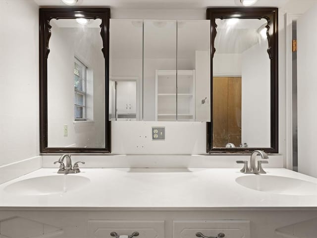 bathroom featuring double vanity and a sink