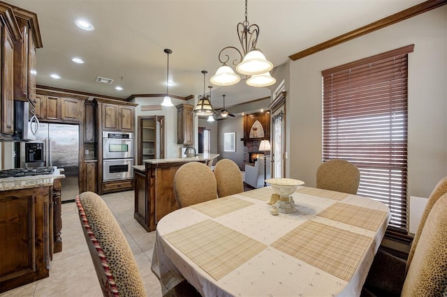 dining space with light tile patterned floors, visible vents, ornamental molding, and recessed lighting