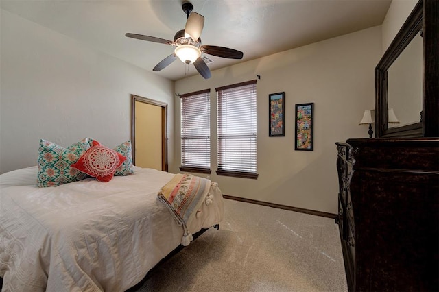 bedroom featuring ceiling fan, baseboards, and carpet