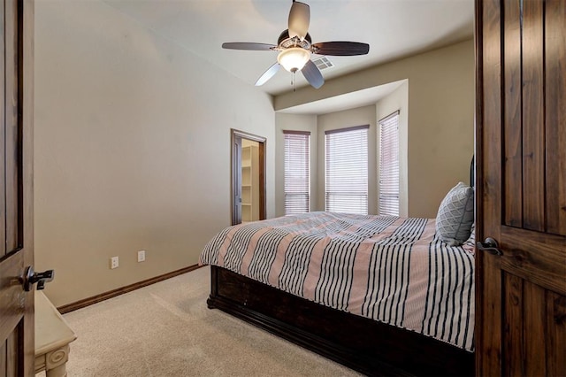 carpeted bedroom with visible vents, baseboards, and a ceiling fan