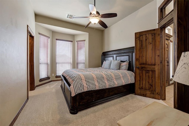 bedroom featuring light carpet, visible vents, ceiling fan, and baseboards