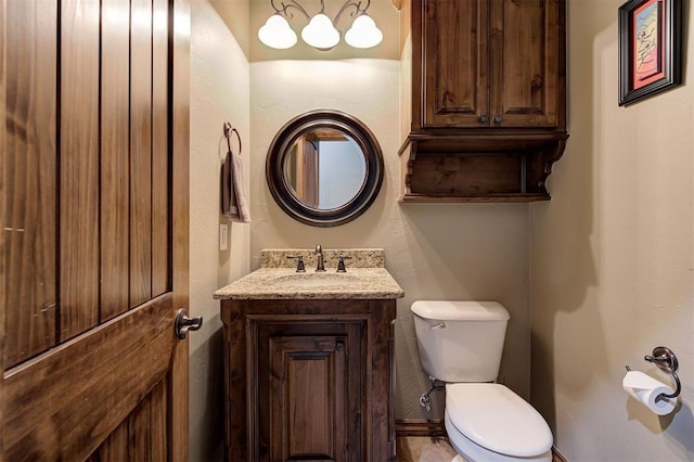 bathroom featuring toilet and vanity