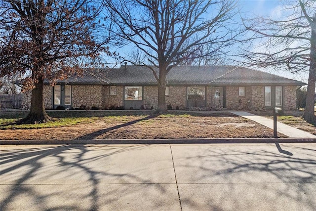 ranch-style home with stone siding