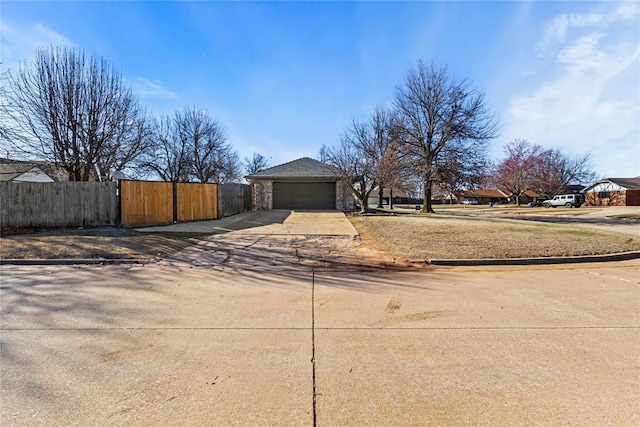 view of yard featuring driveway and fence