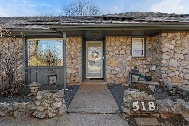 doorway to property with stone siding