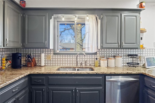 kitchen with dishwasher, gray cabinetry, backsplash, and a sink