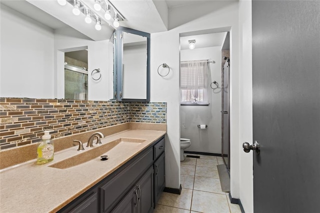 bathroom featuring vanity, tile patterned flooring, walk in shower, toilet, and backsplash