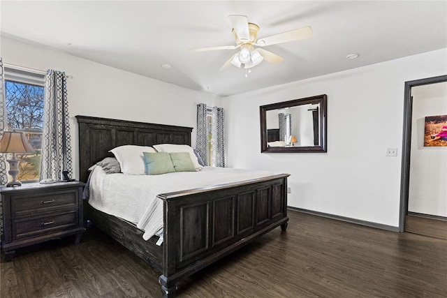 bedroom with dark wood finished floors, ceiling fan, and baseboards