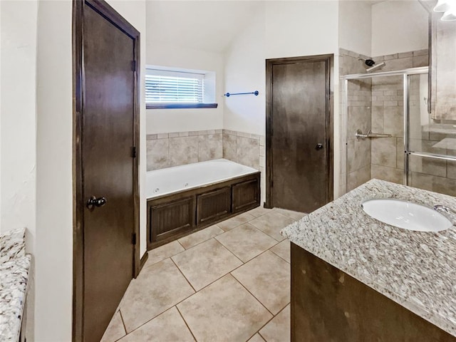 full bath with a whirlpool tub, a shower stall, tile patterned flooring, vanity, and vaulted ceiling