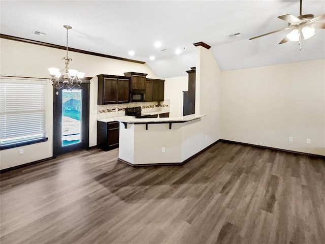 kitchen with visible vents, lofted ceiling, black appliances, dark wood-type flooring, and tasteful backsplash