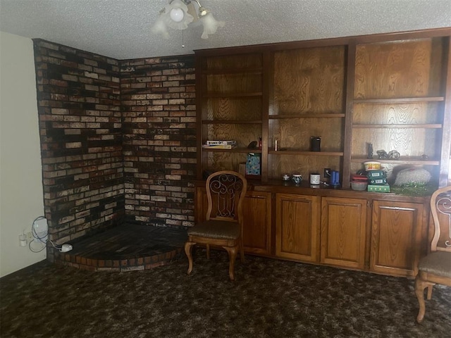 sitting room featuring carpet floors and a textured ceiling