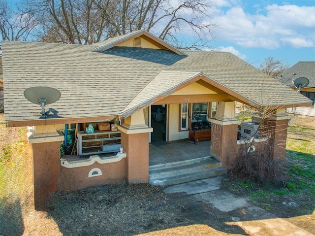 exterior space featuring a shingled roof