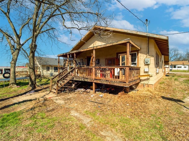 rear view of property with a porch