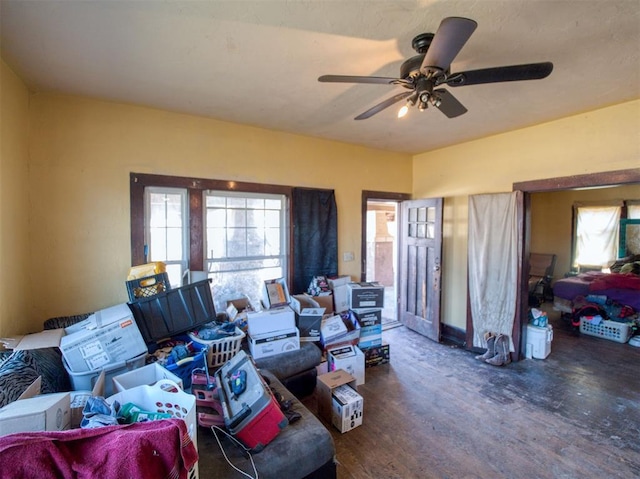 living room featuring a ceiling fan and wood finished floors