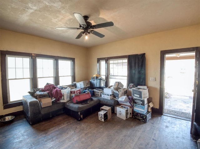 living room with a ceiling fan, wood finished floors, and baseboards