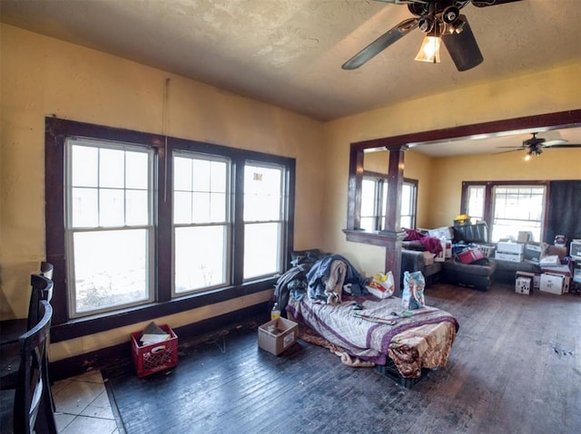 interior space featuring a textured ceiling, a ceiling fan, and hardwood / wood-style flooring